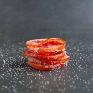 A stack of sugar-coated blood orange slices.
