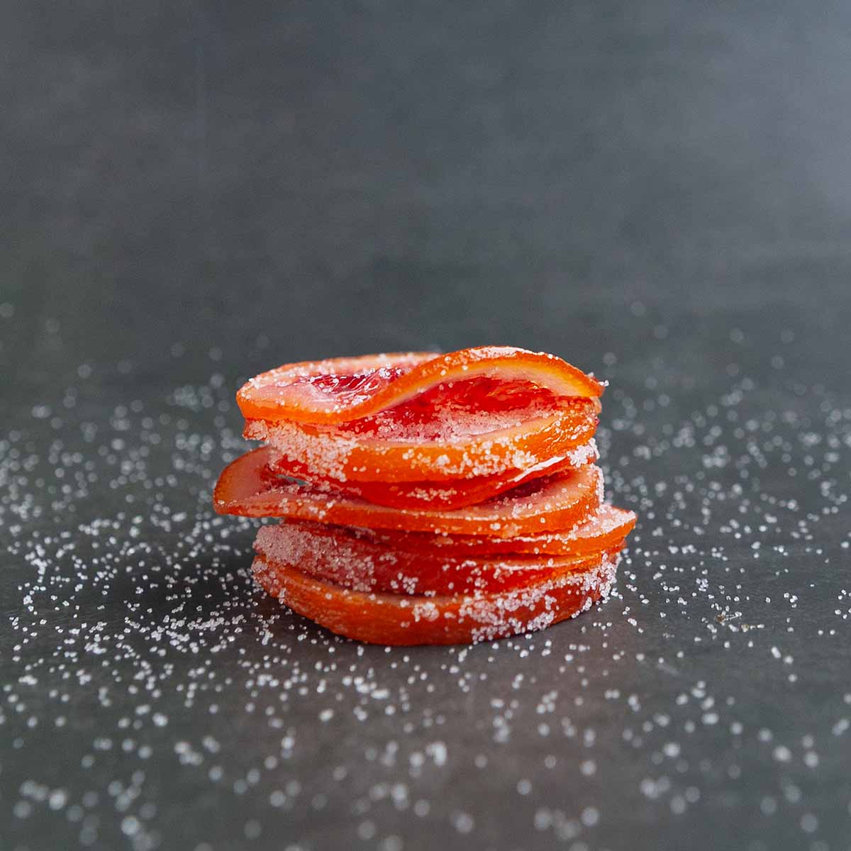 A stack of sugar-coated blood orange slices.