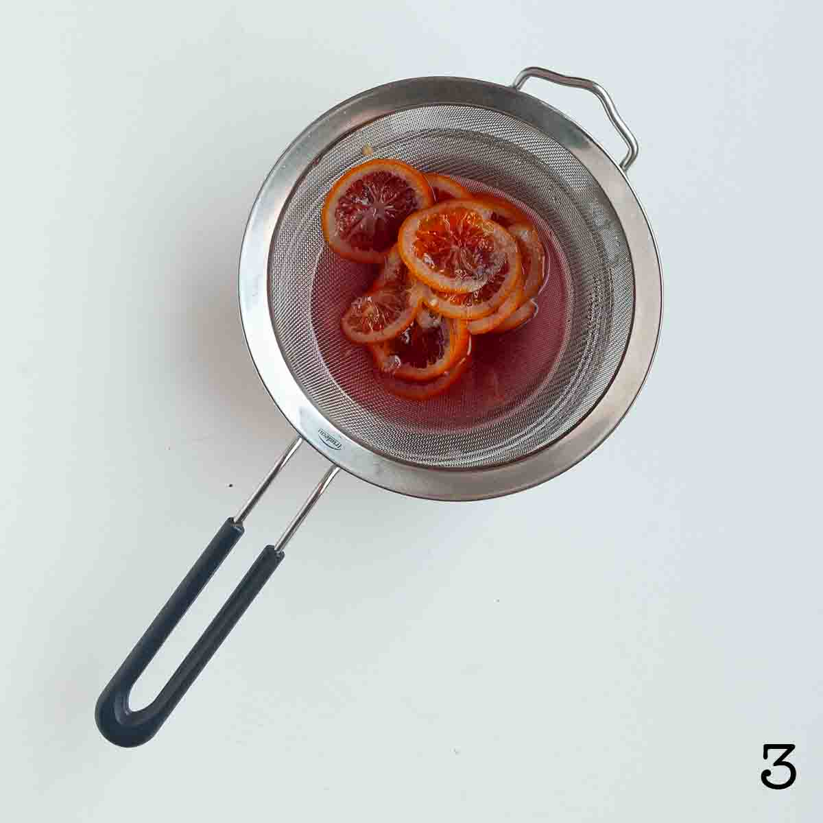 Slices of blood orange in syrup.