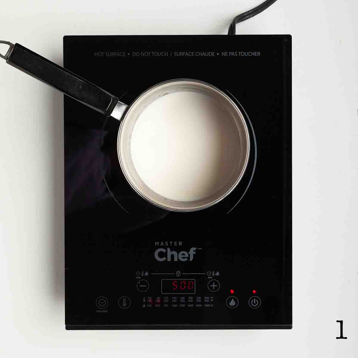 A pot of cream on a burner.