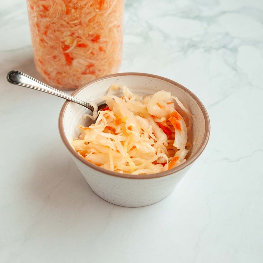 A small dish of sauerkraut with carrots.