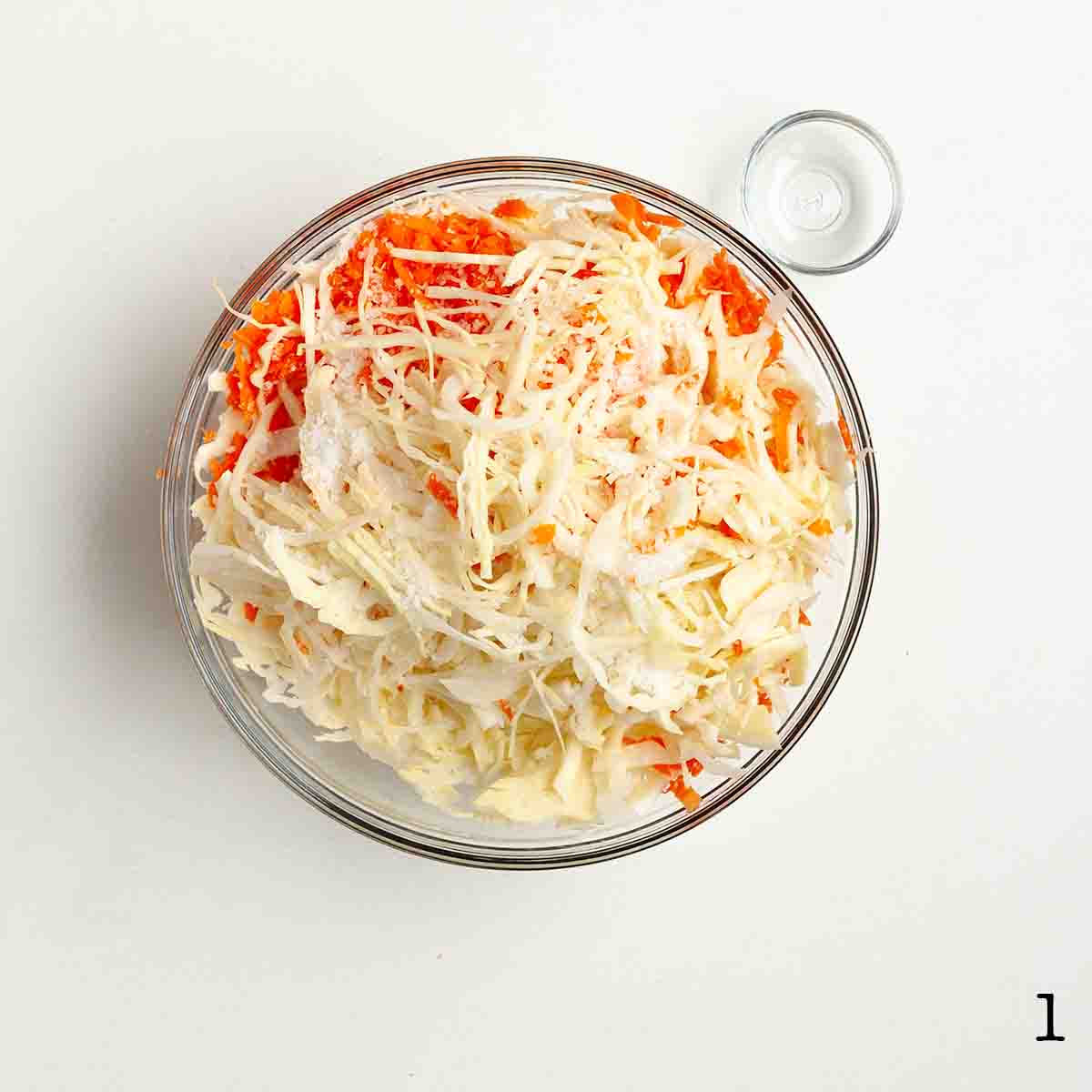 Shredded cabbage and carrots in a bowl.