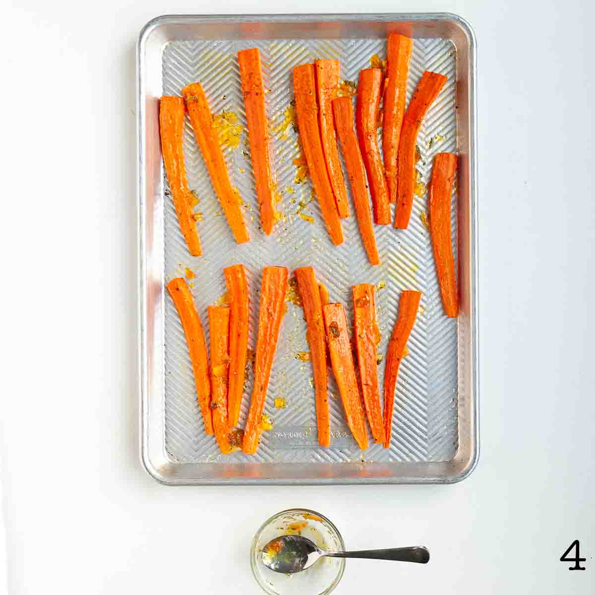Cooked carrots on a baking sheet.