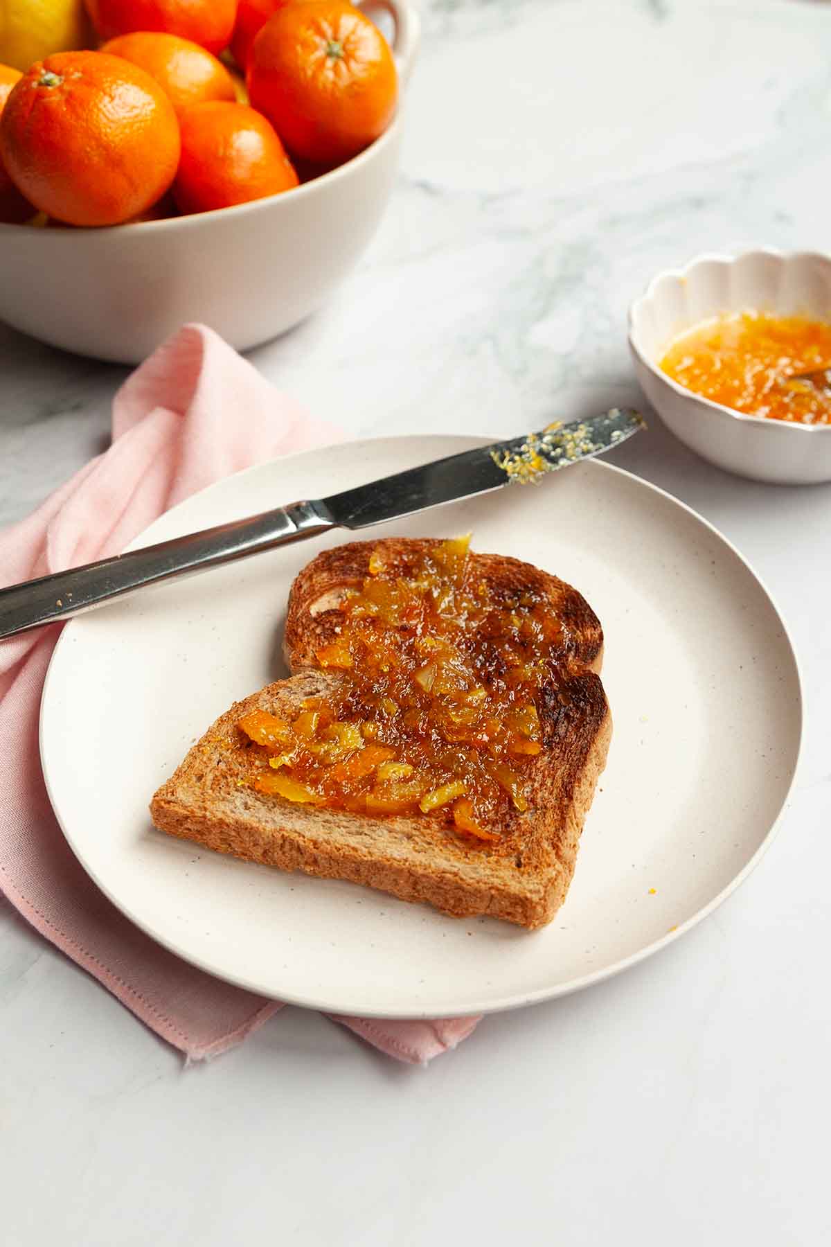 A slice of toast topped with marmalade.
