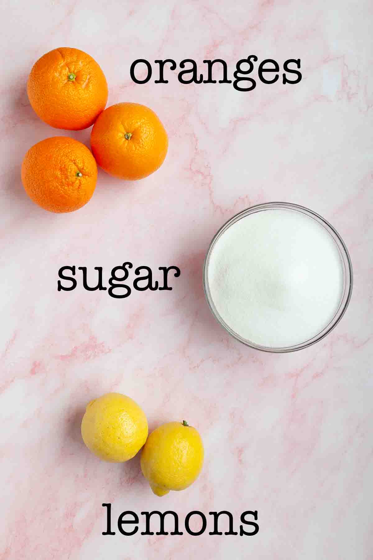 Ingredients for orange and lemon marmalade--oranges, sugar, lemons.