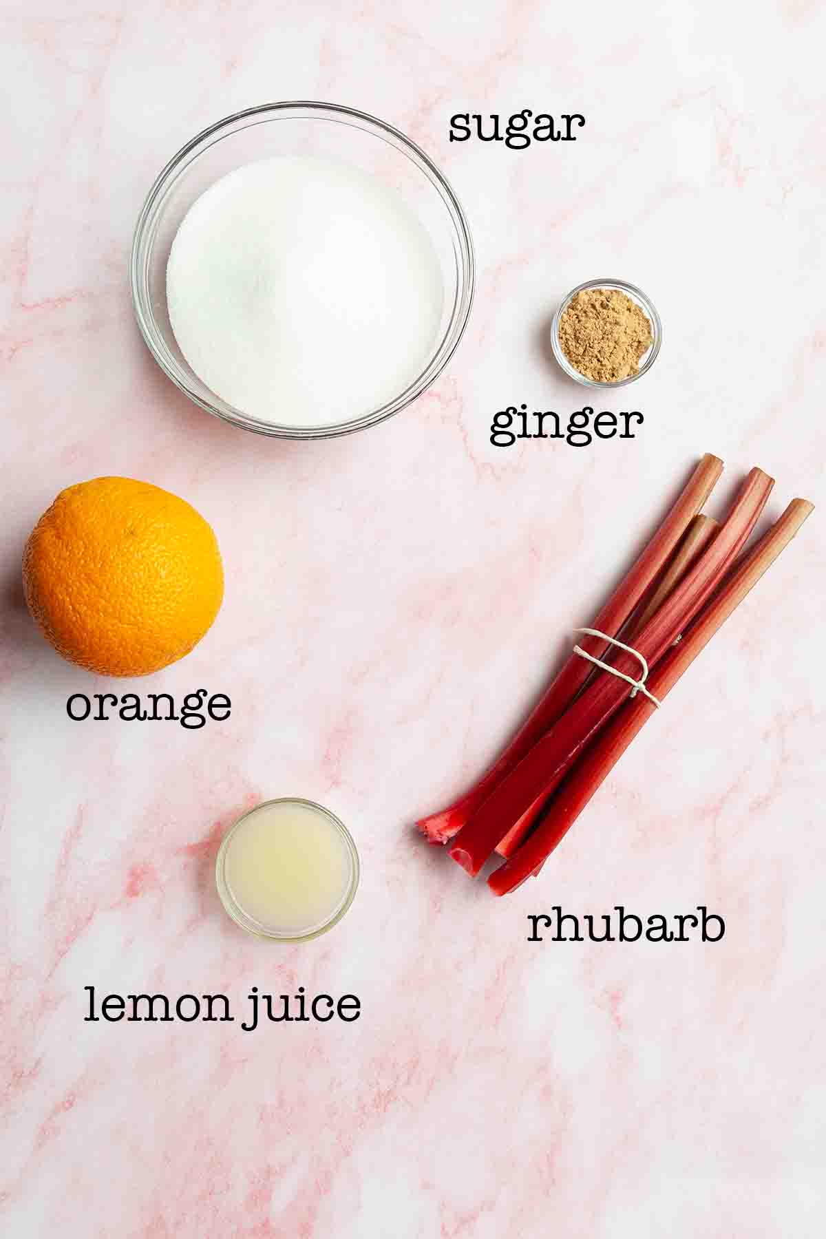 Ingredients for rhubarb ginger jam-sugar, ginger, orange, lemon juice, and rhubarb.