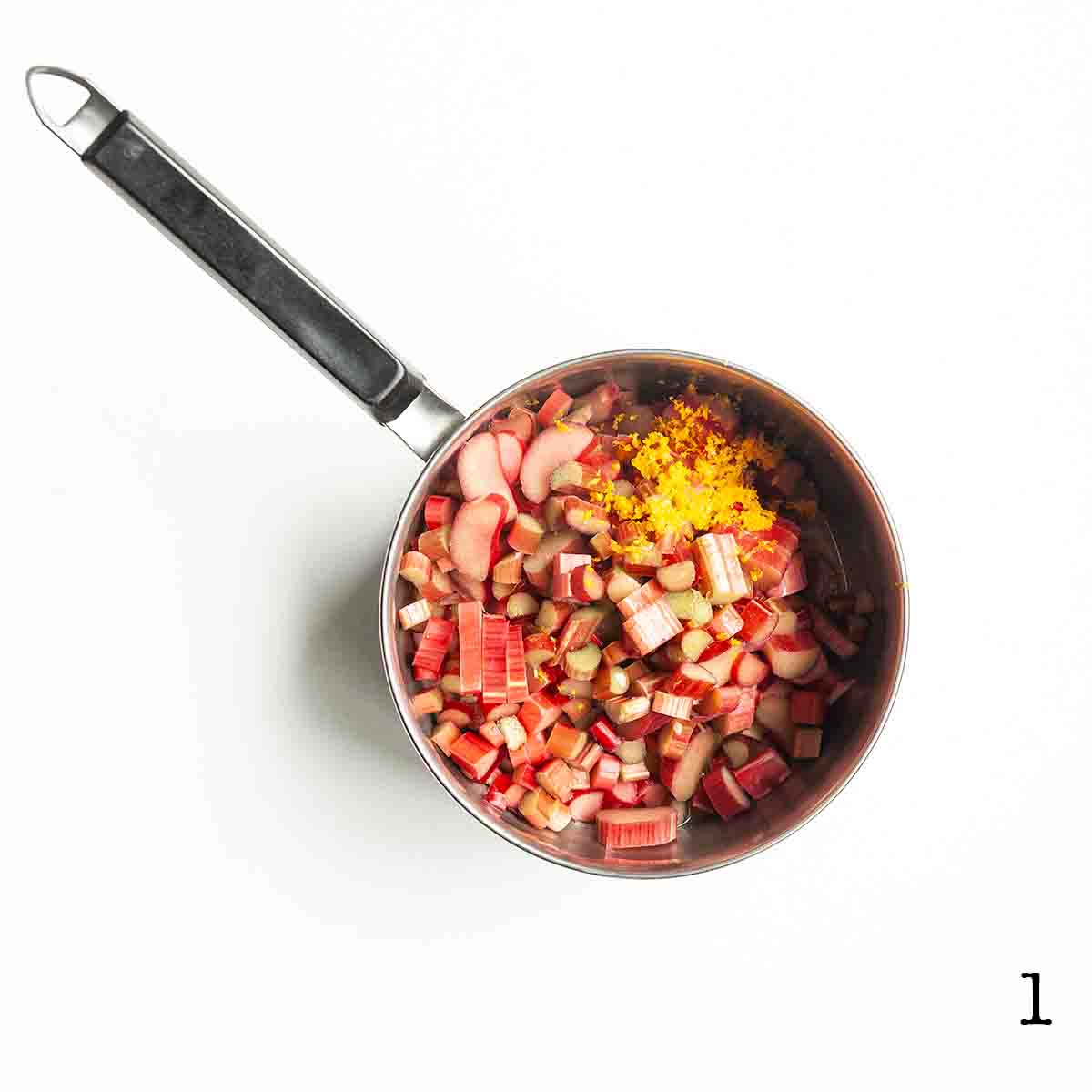 A pot filled with chopped rhubarb and orange zest.
