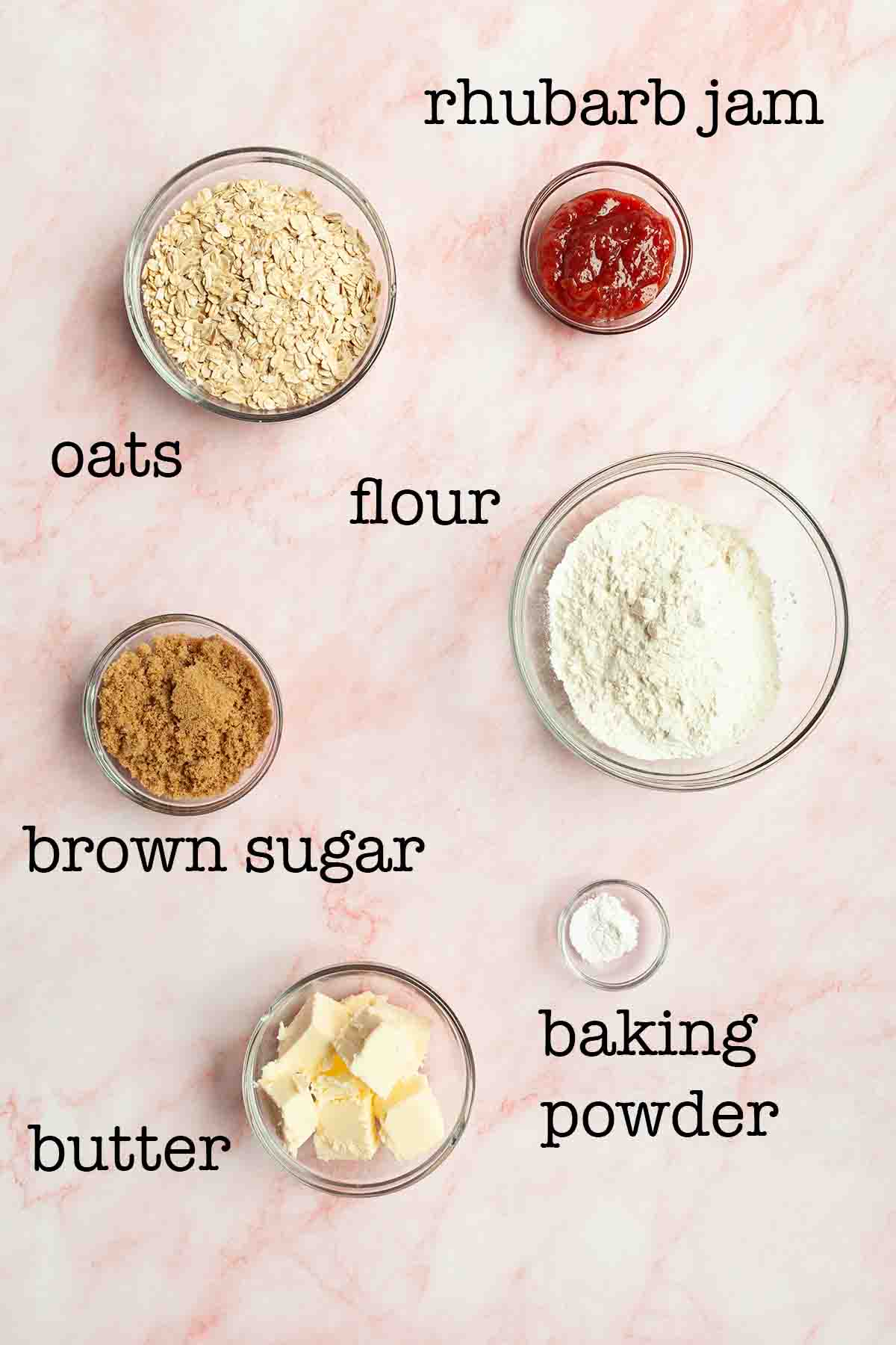 Ingredients for oat bars--oats, jam, flour, brown sugar, butter, and baking powder.