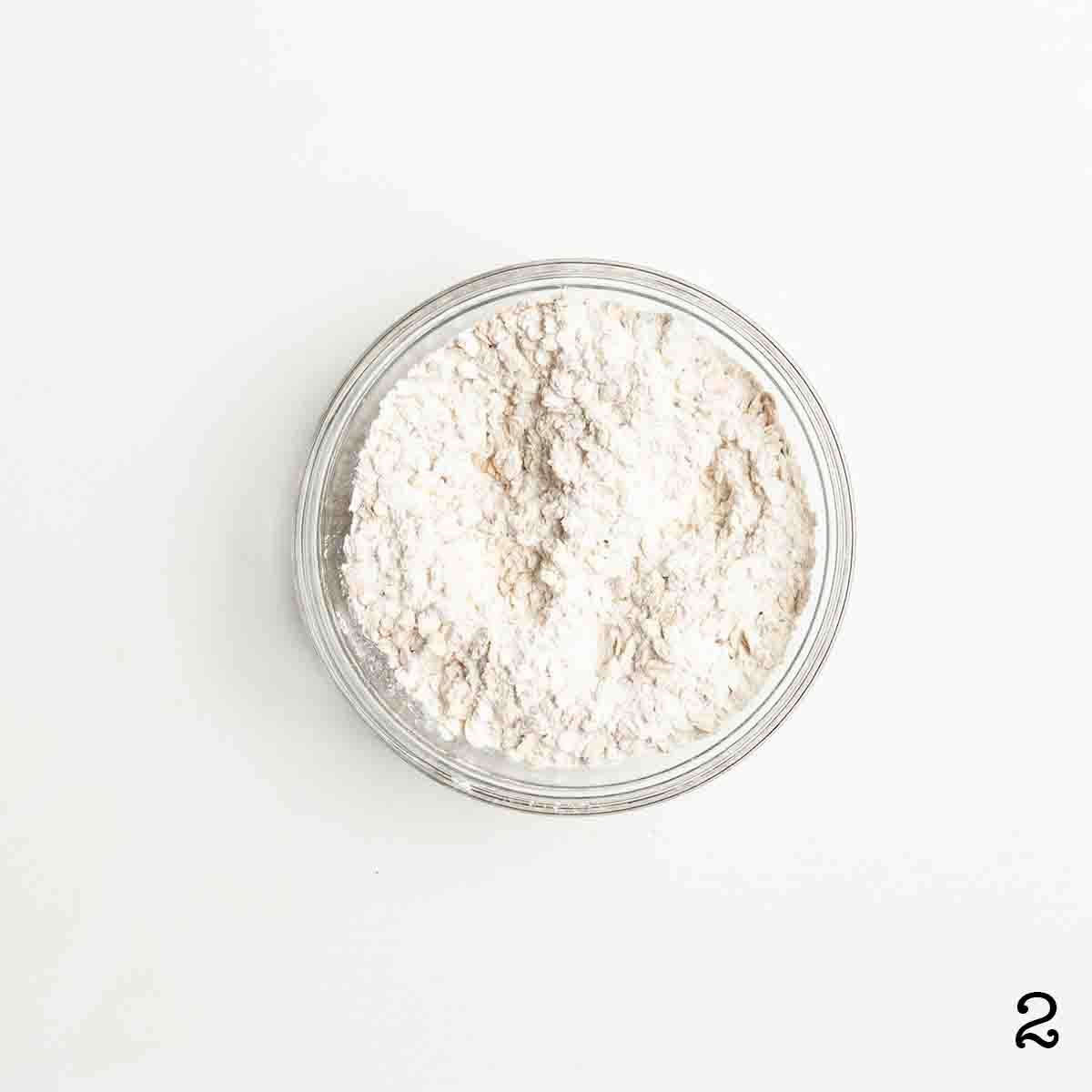 A bowl of flour and oats mixed together.