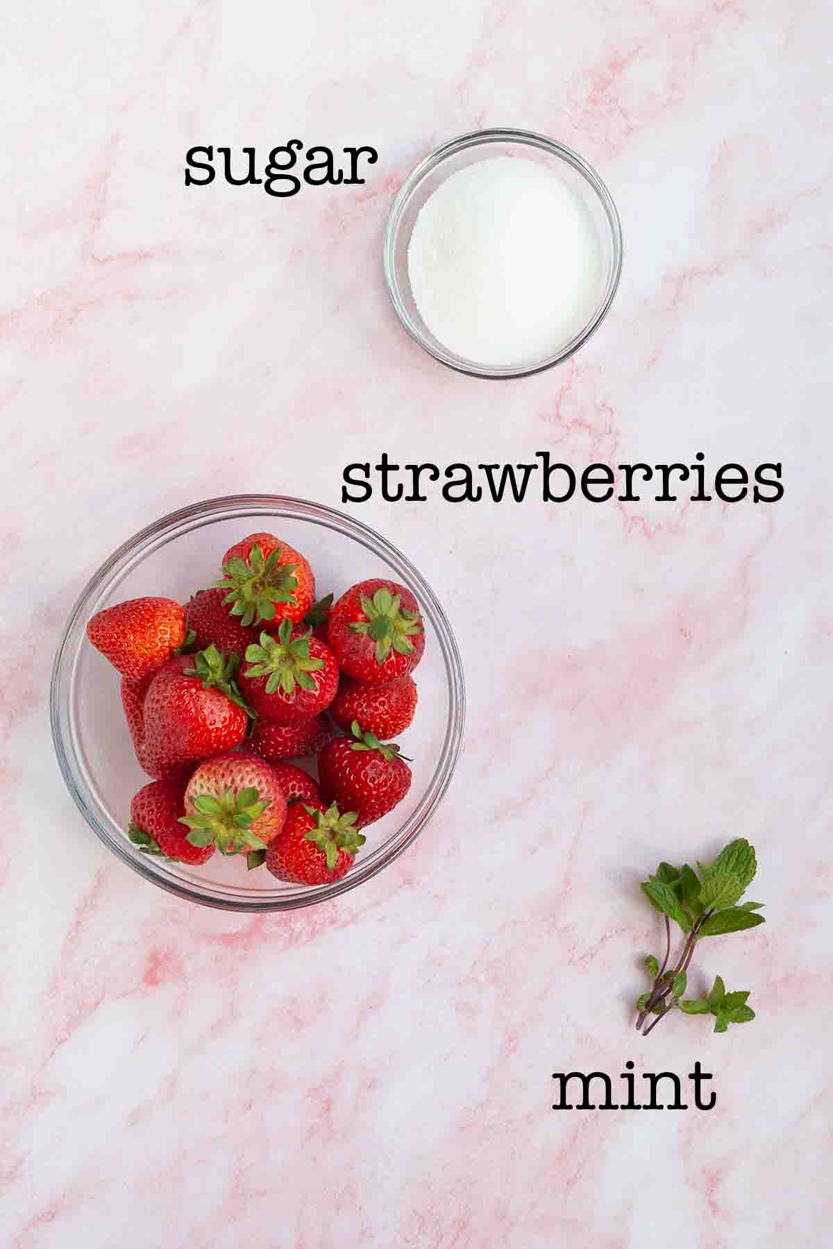 Ingredients for strawberry mint syrup--strawberries, sugar, and mint.
