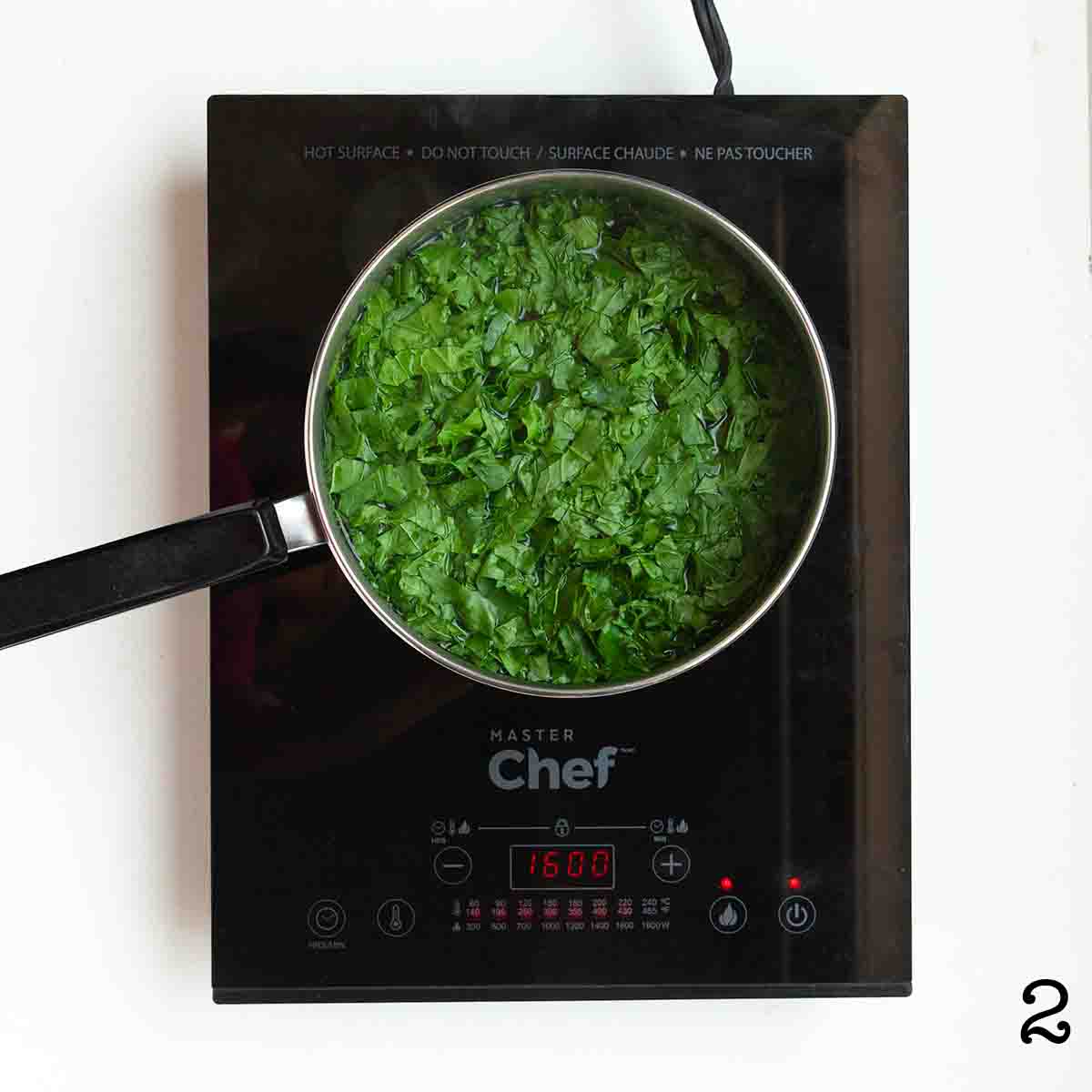 Kale cooking in a pot of water.