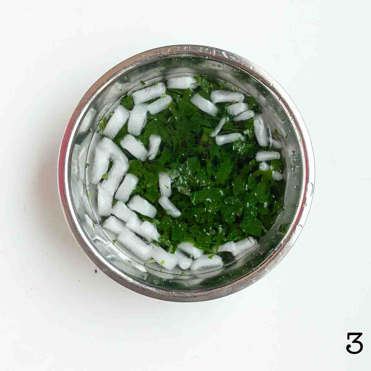Cooked kale in an ice bath.