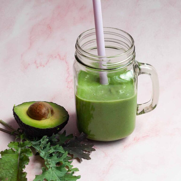 A mug filled with green smoothie.