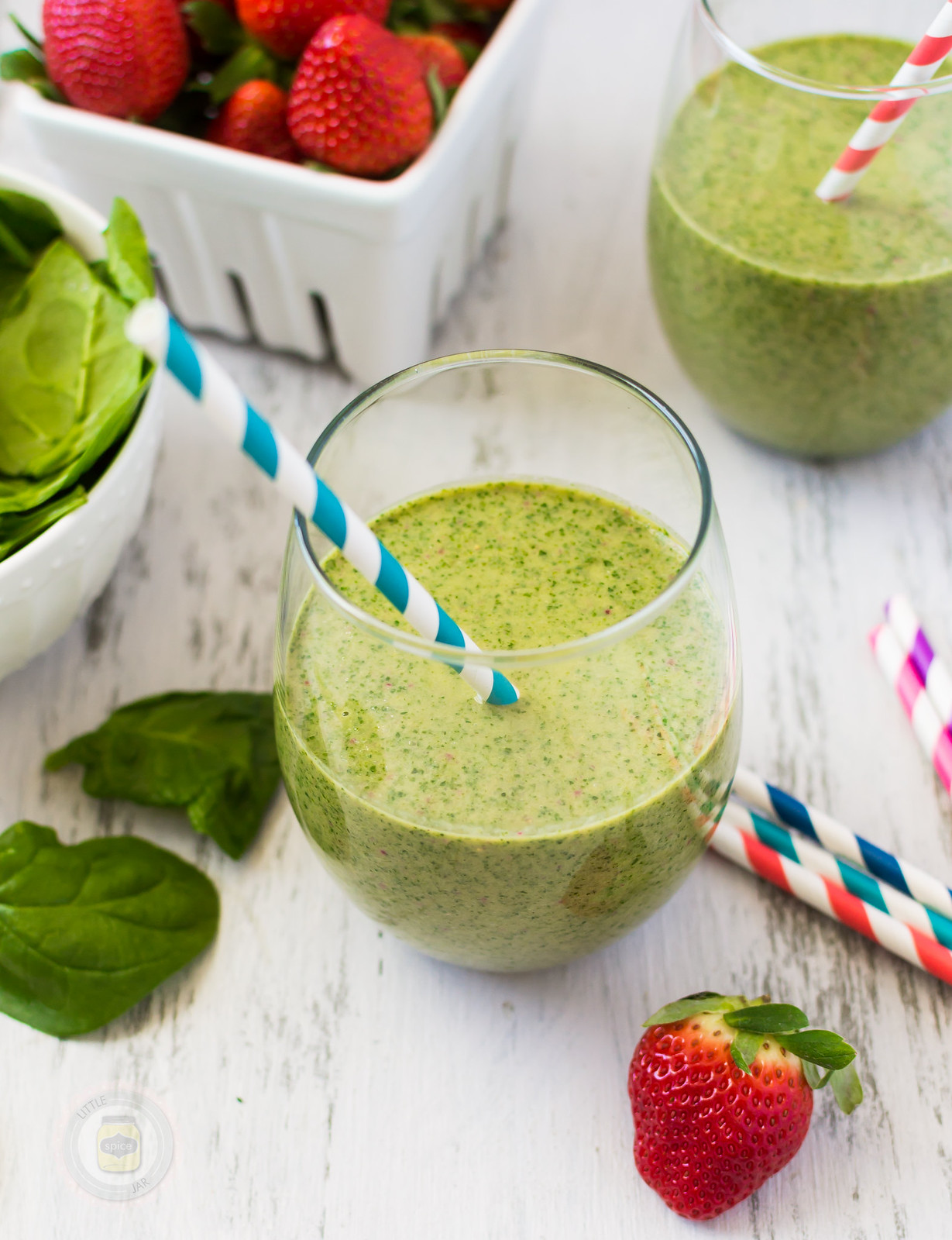 A glass filled with a green smoothie.
