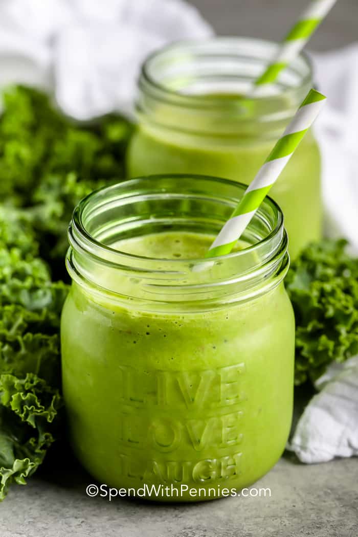 Two jars filled with green smoothie.