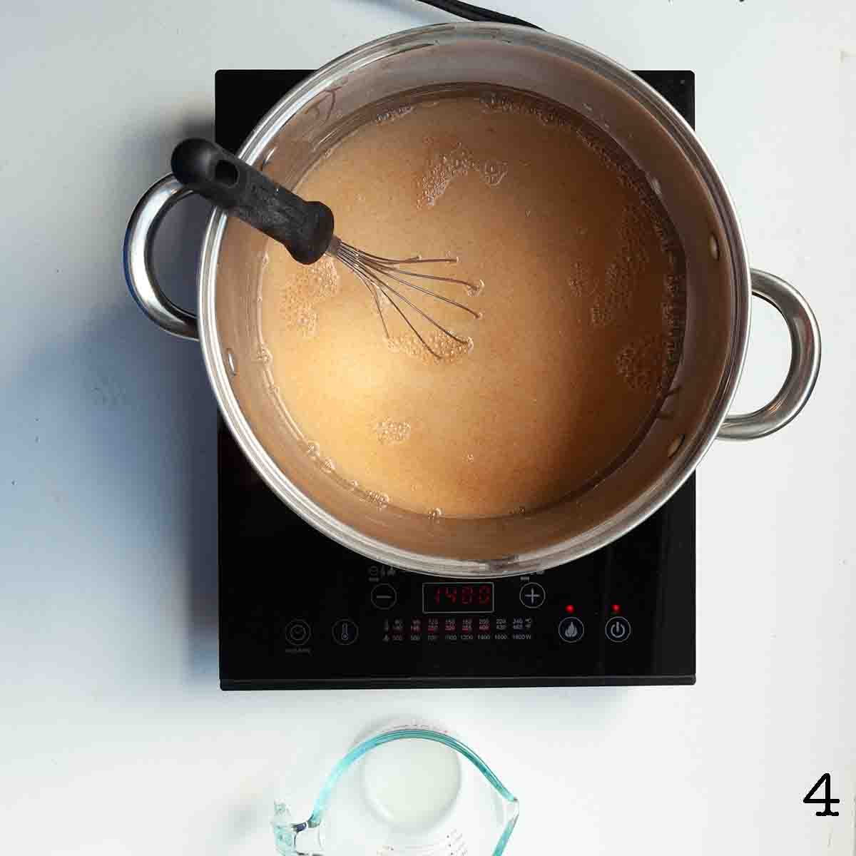 Pie filling cooking in a large pot.