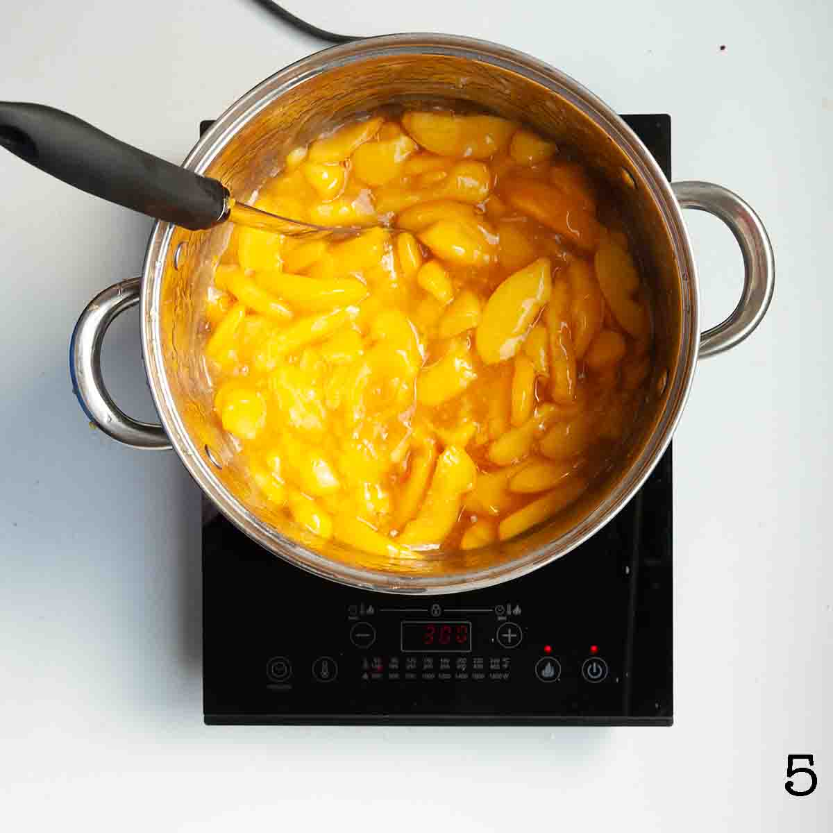 Peach pie filling in a large pot.