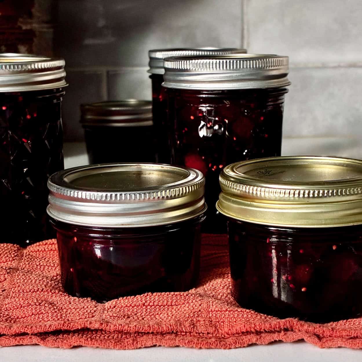 Sealed jars of mulberry jam.