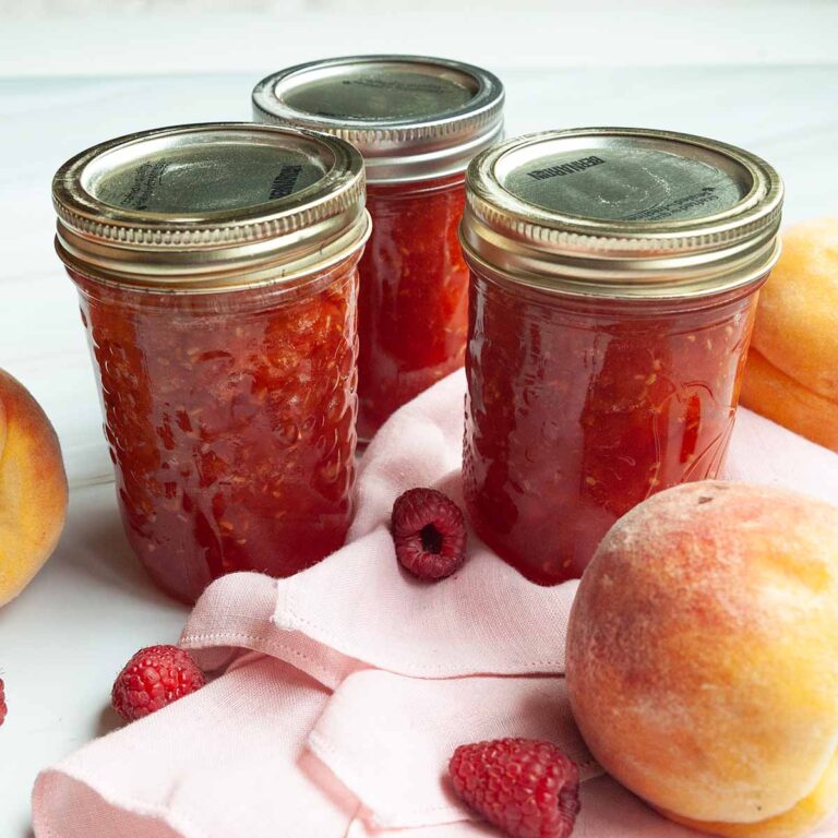 Three jars of peach raspberry jam.