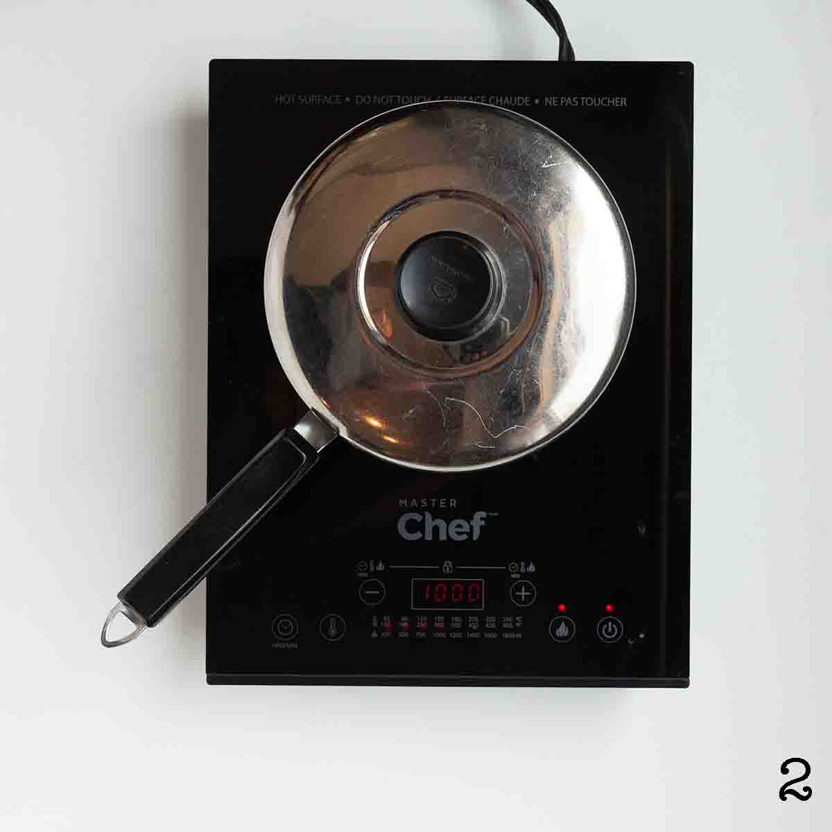 A covered pot on a burner.