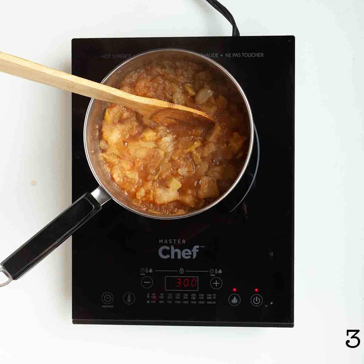 Partially mashed applesauce in a pot.