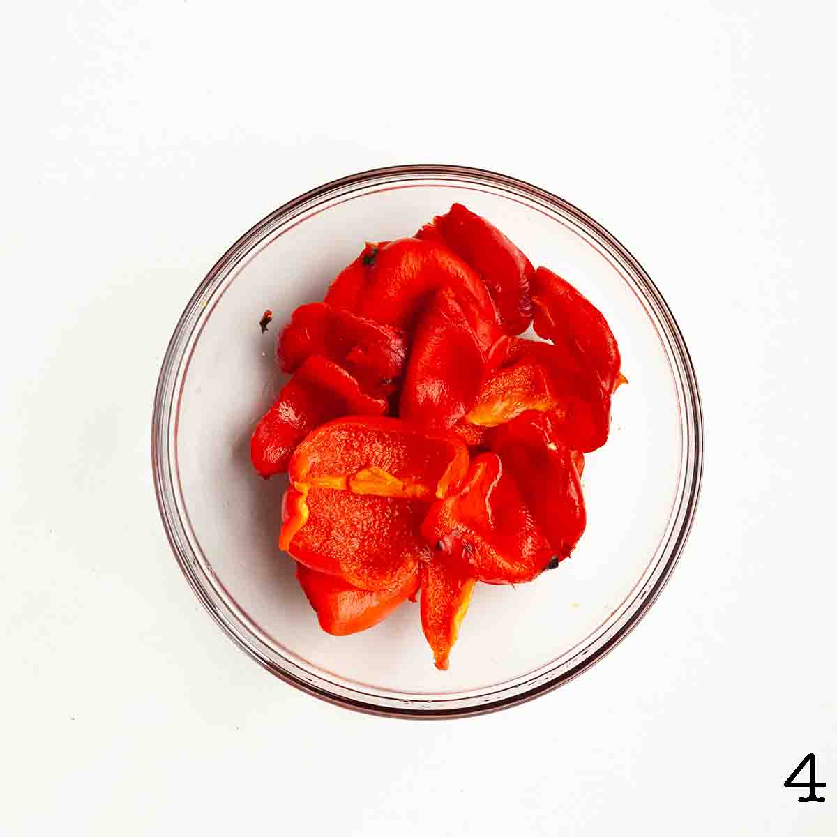 Peeled roasted red peppers in a bowl.