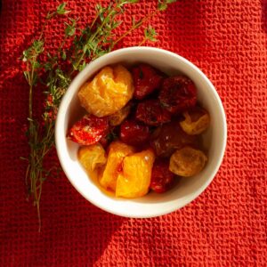 A dish filled with roasted cherry tomatoes.