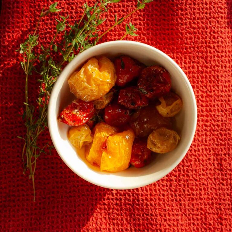 A dish filled with roasted cherry tomatoes.